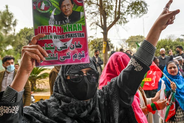 <p>Pakistan’s imprisoned former prime minister Imran Khan’s supporters hold Khan’s portrait during a protest in Peshawar on 17 January 2025</p>